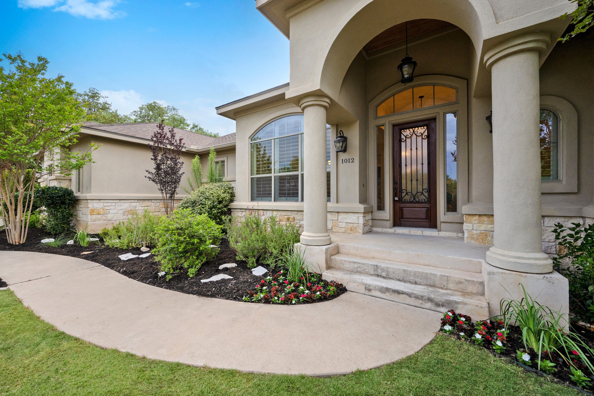 1012 Sailmaster Street Lakeway, TX 78734 - Photo 24 of 26 a front view of a house with garden