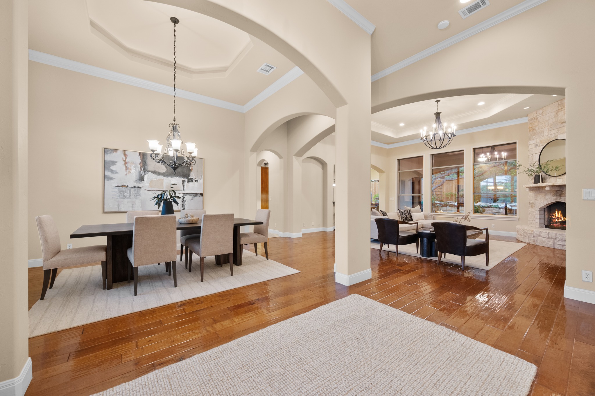 1012 Sailmaster Street Lakeway, TX 78734 - Photo 3 of 26 a living room with furniture a chandelier and a dining table