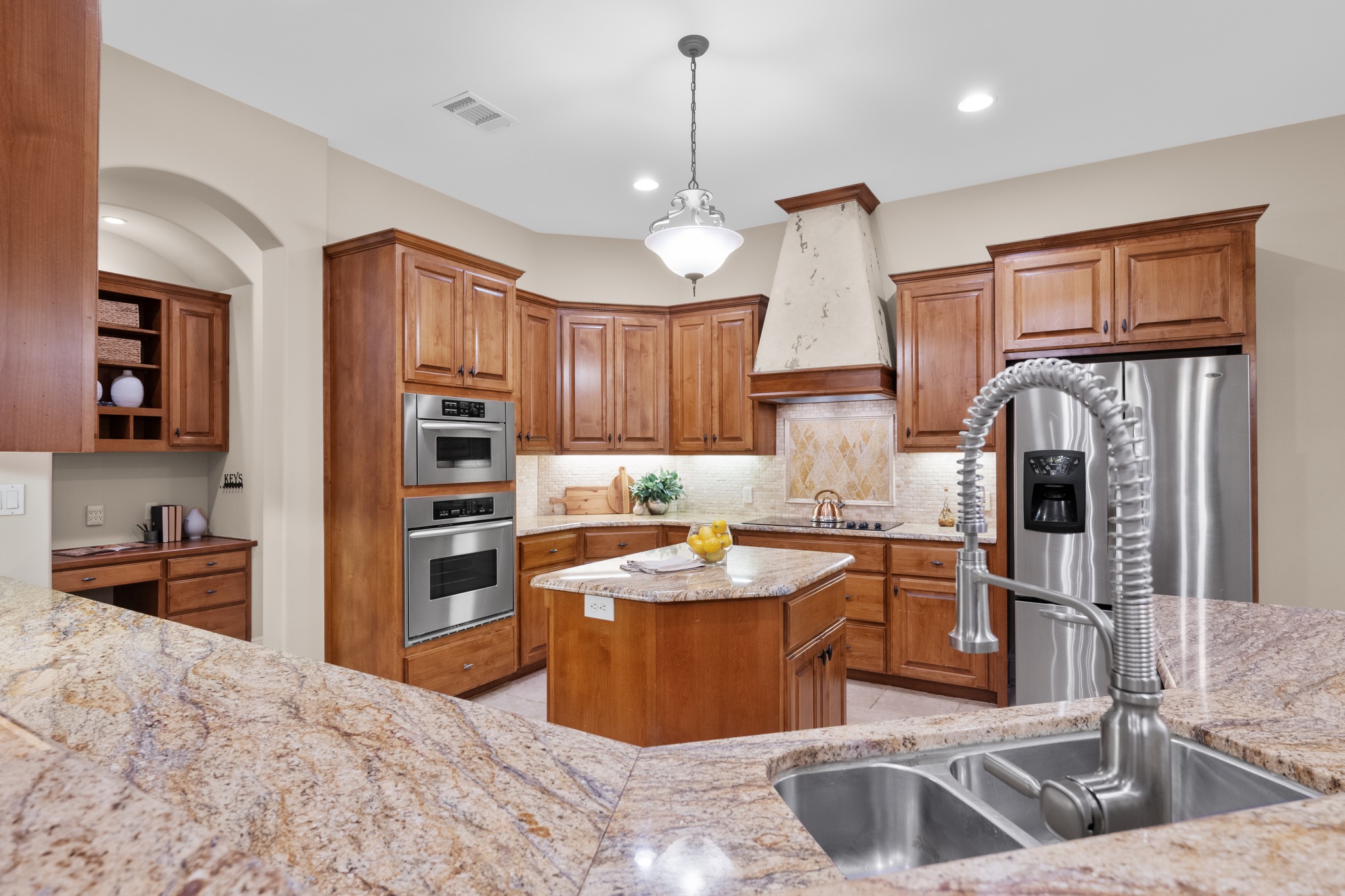 1012 Sailmaster Street Lakeway, TX 78734 - Photo 8 of 26 a kitchen with stainless steel appliances granite countertop a sink refrigerator and cabinets