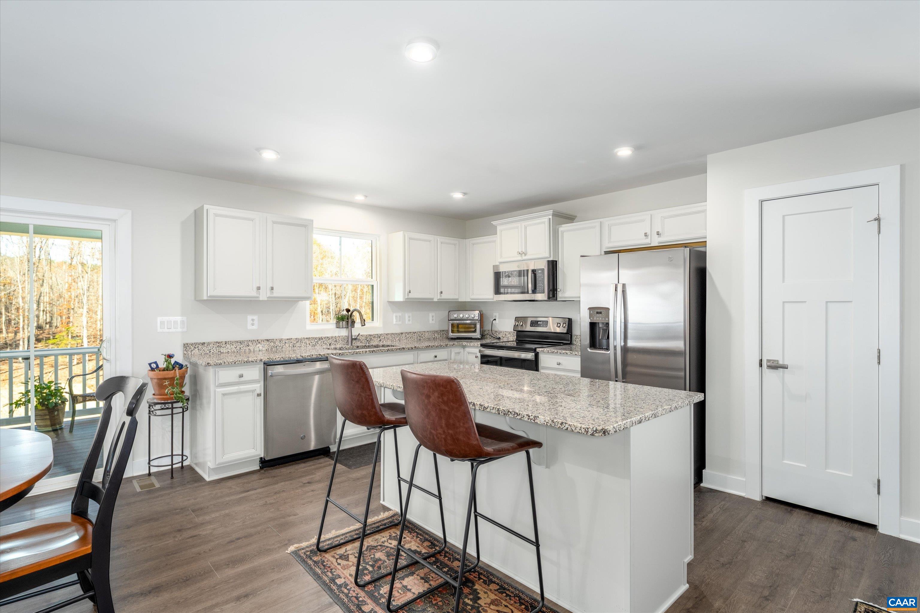 93 Archer Drive Palmyra, VA 22963 - Photo 13 of 45 a kitchen with granite countertop a center island stainless steel appliances cabinets and a window