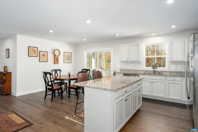 a kitchen with center island table and chairs