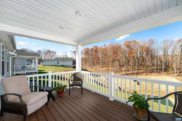a view of a chairs and table on the roof deck