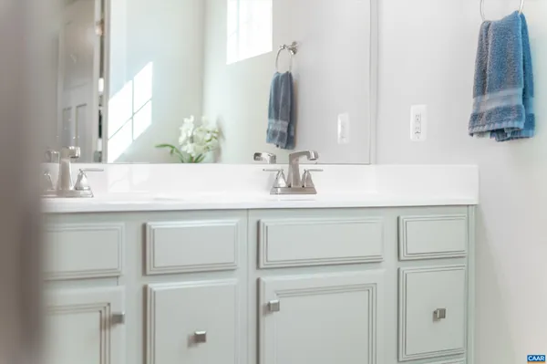 a bathroom with a sink vanity and a mirror