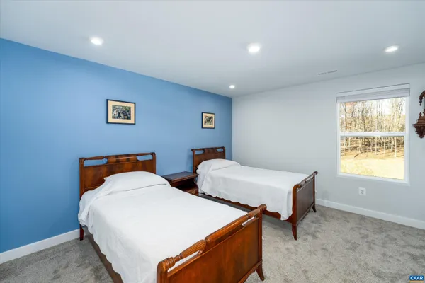 a bedroom with two beds and a window