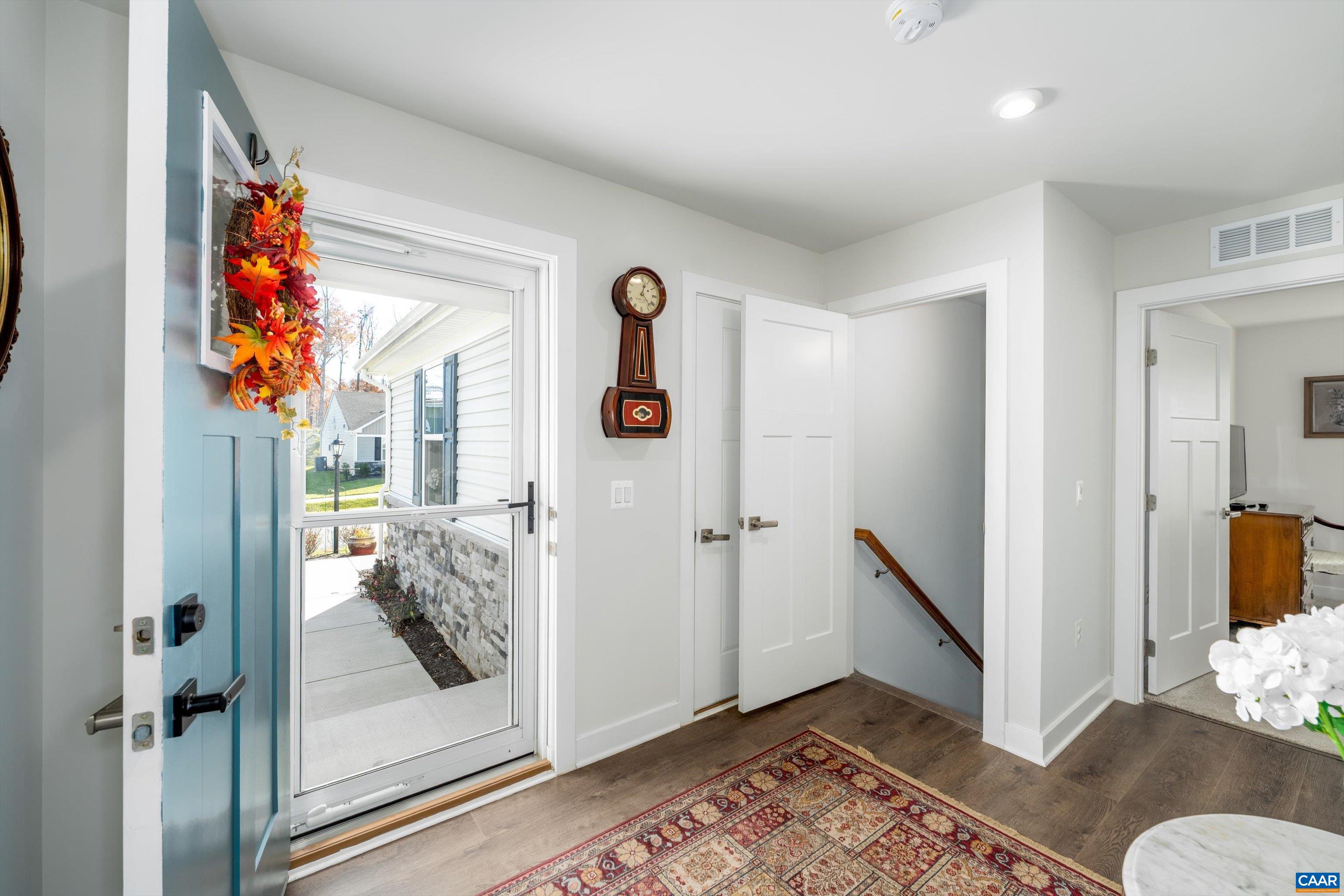 93 Archer Drive Palmyra, VA 22963 - Photo 5 of 45 a view of a hallway to a livingroom with wooden floor and white walls