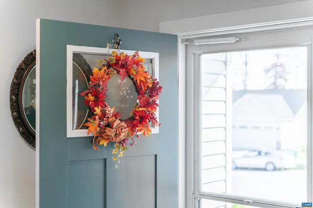 a vase of flowers sitting on a floor next to a window