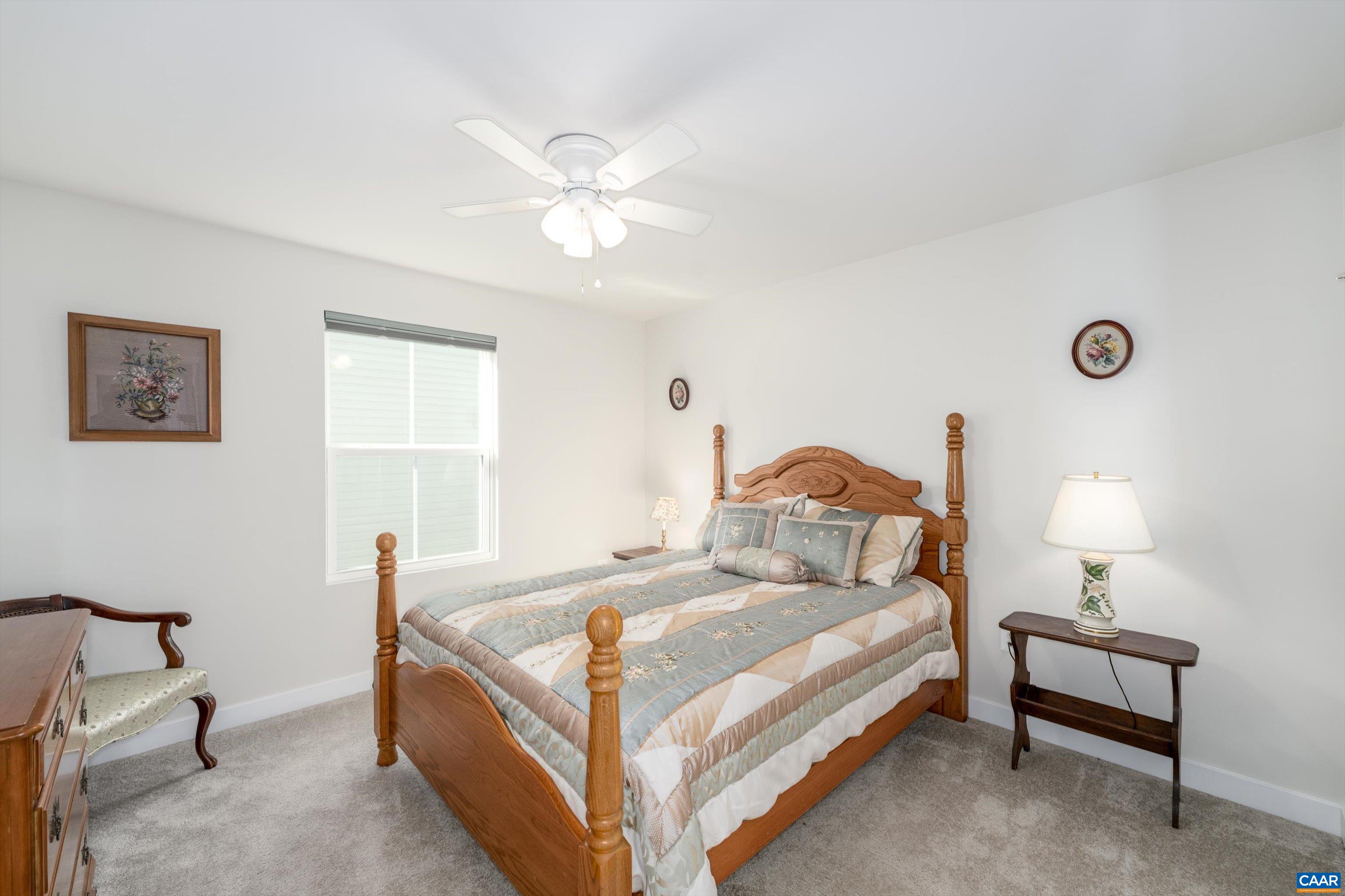 93 Archer Drive Palmyra, VA 22963 - Photo 8 of 45 a bedroom with a bed and a chandelier