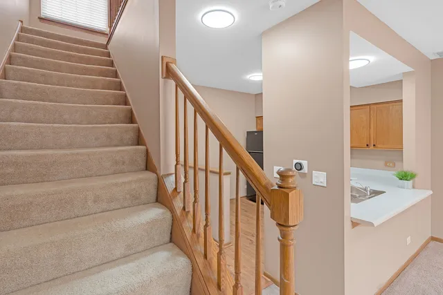 a view of staircase with white walls and a window