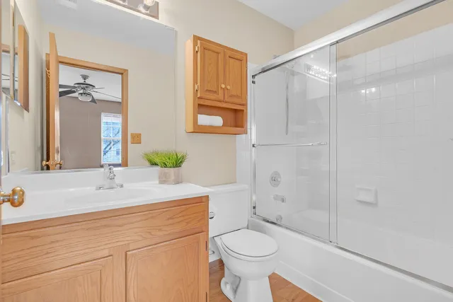 a bathroom with a sink toilet and shower