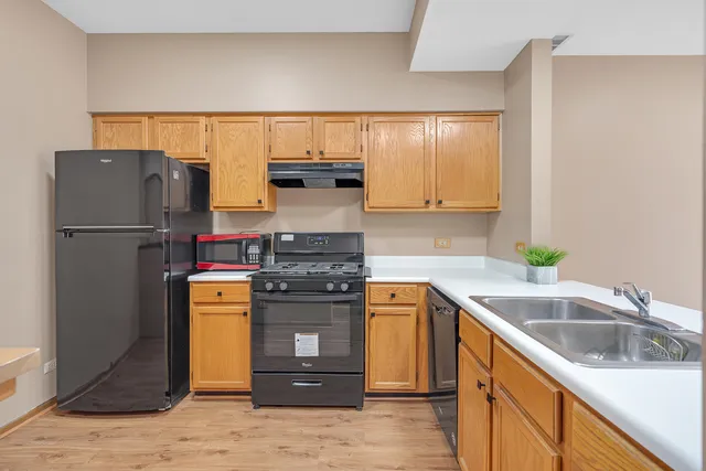 a kitchen with a refrigerator and a sink