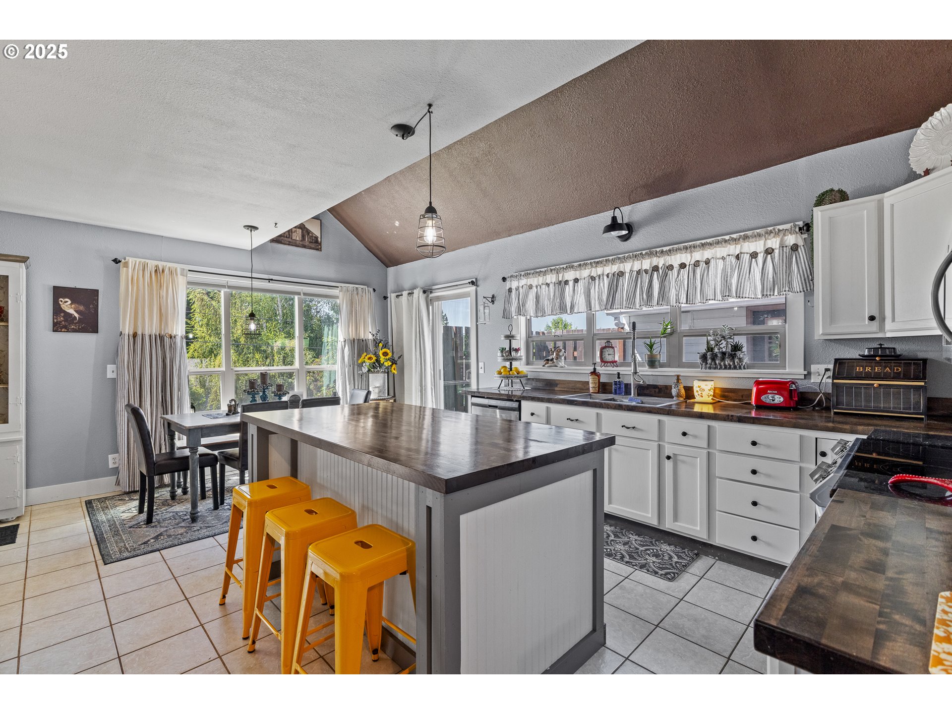 1753 20th Street Myrtle Point, OR 97458 - Photo 11 of 44 a kitchen with stainless steel appliances kitchen island granite countertop a table chairs and a refrigerator