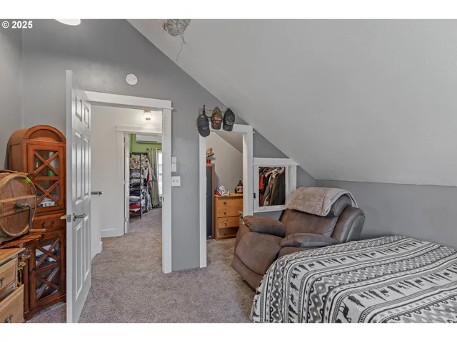 a bedroom with a bed next to a window