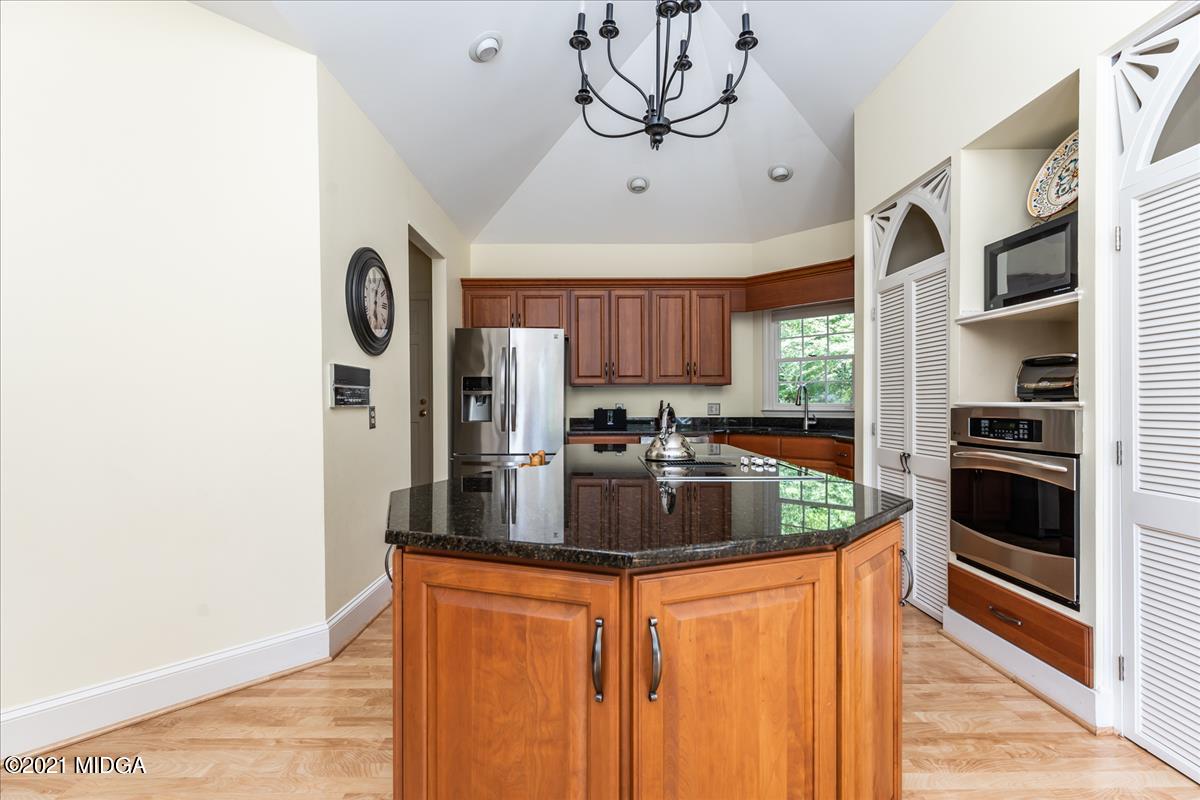 135 Rivoli Ridge Drive Macon, GA 31210 - Photo 11 of 46 a kitchen with stainless steel appliances granite countertop a refrigerator a stove and a sink with cabinets