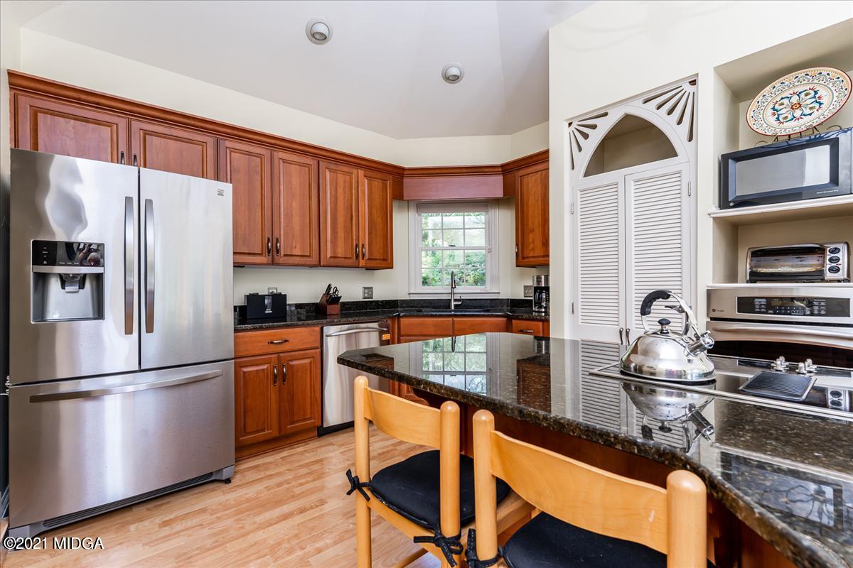 135 Rivoli Ridge Drive Macon, GA 31210 - Photo 12 of 46 a kitchen with stainless steel appliances granite countertop a refrigerator a stove and a sink