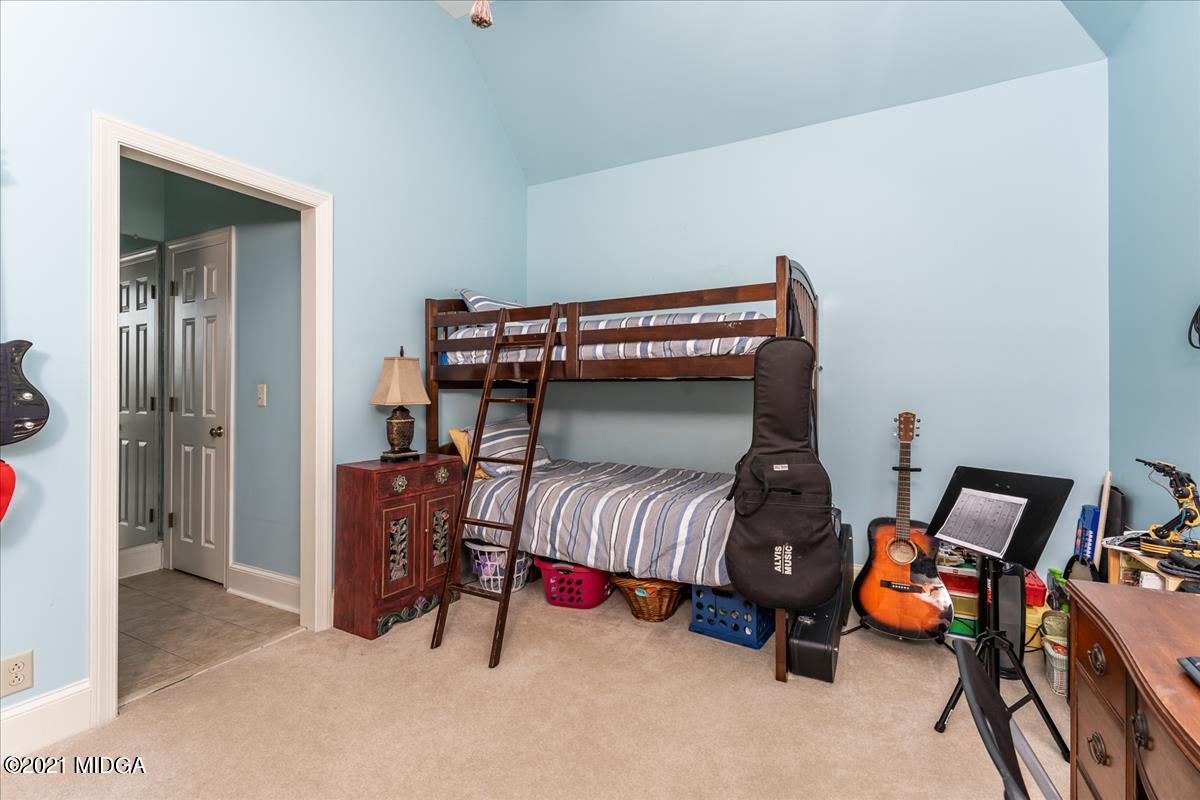 135 Rivoli Ridge Drive Macon, GA 31210 - Photo 21 of 46 a bedroom with furniture and a lamp