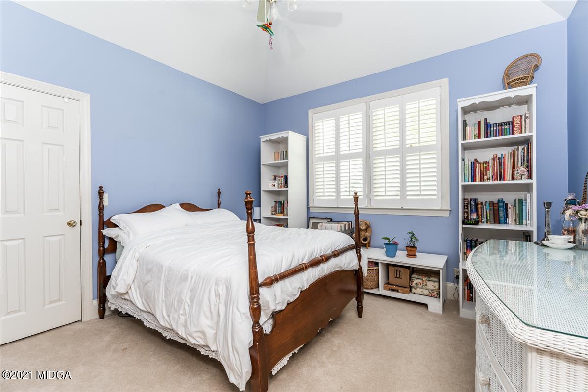 135 Rivoli Ridge Drive Macon, GA 31210 - Photo 23 of 46 a bed sitting in a bedroom next to a window