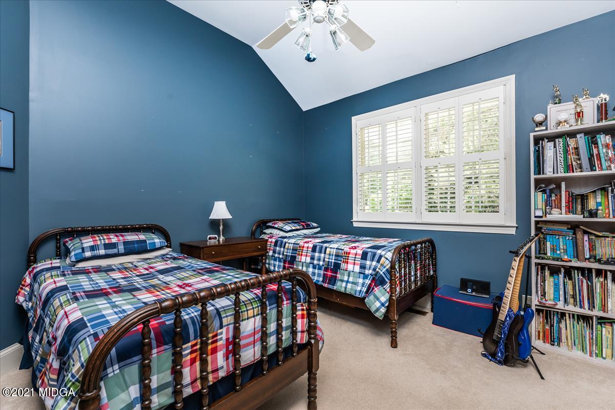 135 Rivoli Ridge Drive Macon, GA 31210 - Photo 25 of 46 a bedroom with two beds and a book shelf