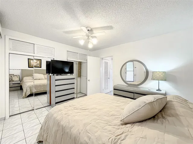 a bedroom with a bed and ceiling fan