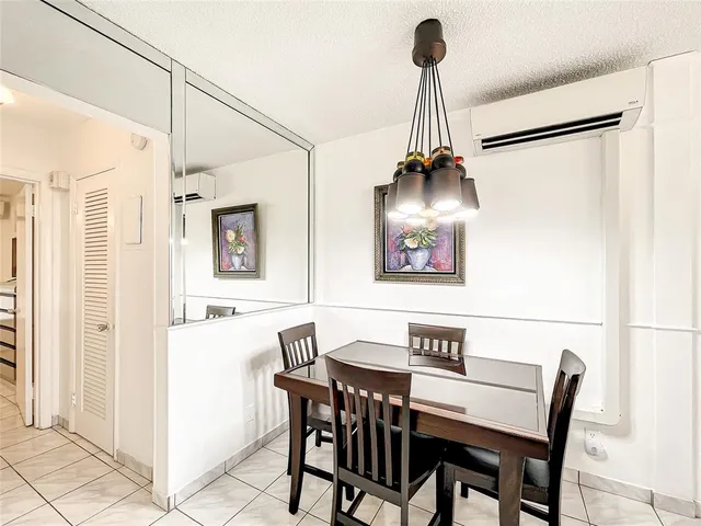 a view of a dining room with furniture wooden floor and a chandelier