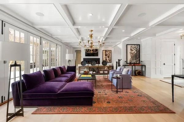 a living room with furniture and a chandelier