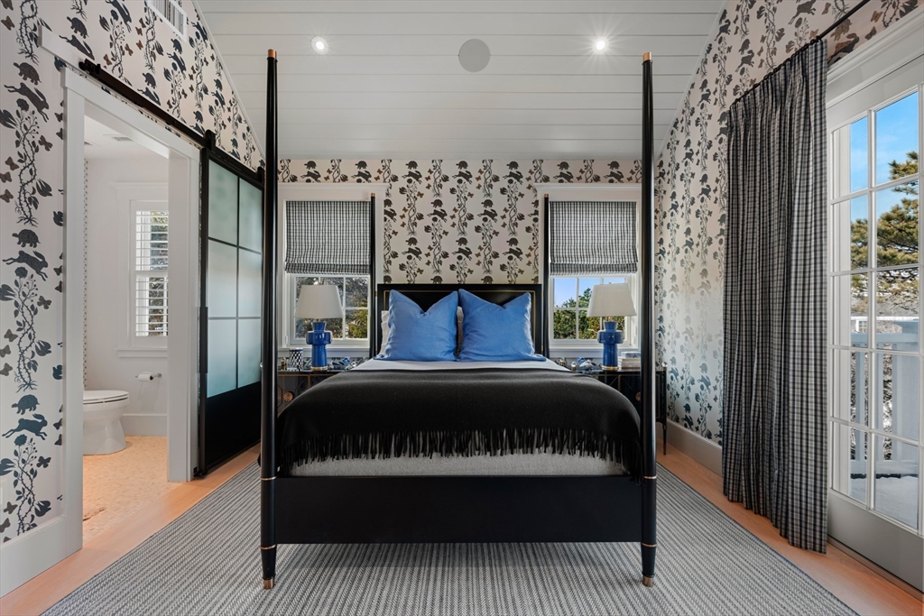 34 Brewster Road Nantucket, MA 02554 - Photo 21 of 40 a bed sitting in a bedroom next to a bathroom