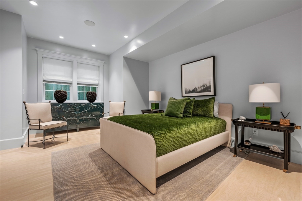 34 Brewster Road Nantucket, MA 02554 - Photo 31 of 40 a spacious bedroom with a bed a table window and couch