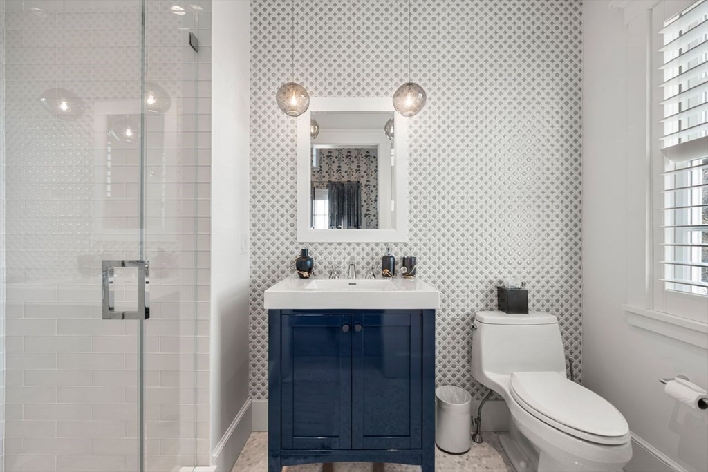34 Brewster Road Nantucket, MA 02554 - Photo 32 of 40 a bathroom with a toilet a sink a mirror and a window