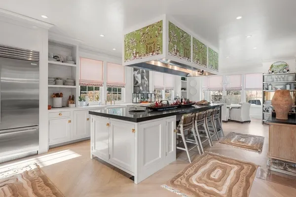 a kitchen with stainless steel appliances granite countertop a sink and cabinets