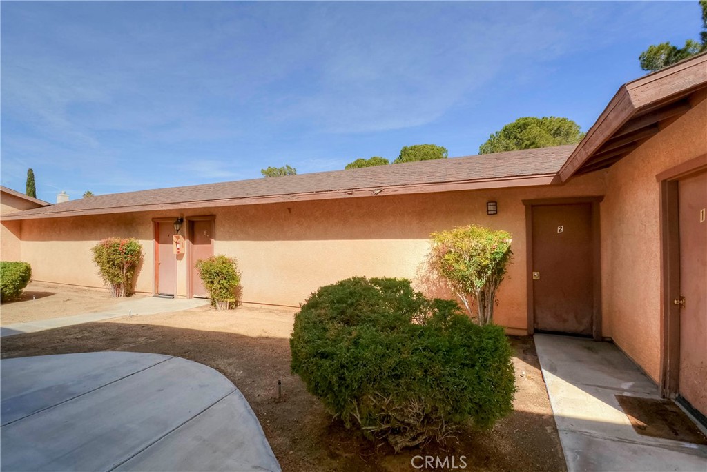 16462 Kalo Road Apple Valley, CA 92307 - Photo 12 of 22 a front view of a house with a yard and garage