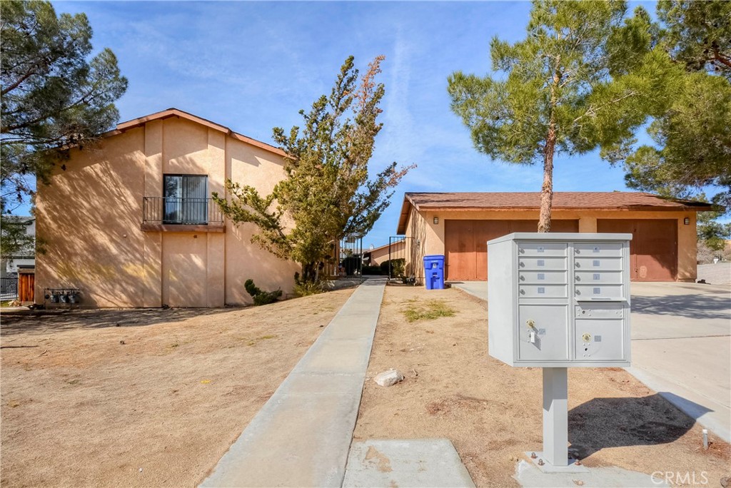 16462 Kalo Road Apple Valley, CA 92307 - Photo 8 of 22 a front view of a house with a yard