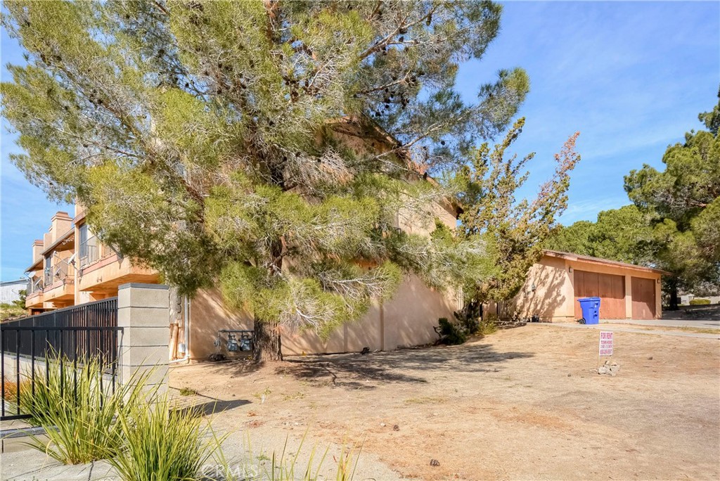 16462 Kalo Road Apple Valley, CA 92307 - Photo 10 of 22 a view of a yard with plants and trees