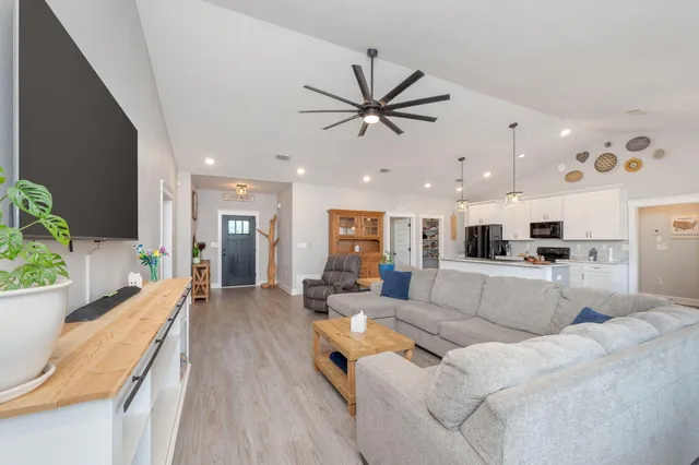 a kitchen with a refrigerator a stove a sink and cabinets