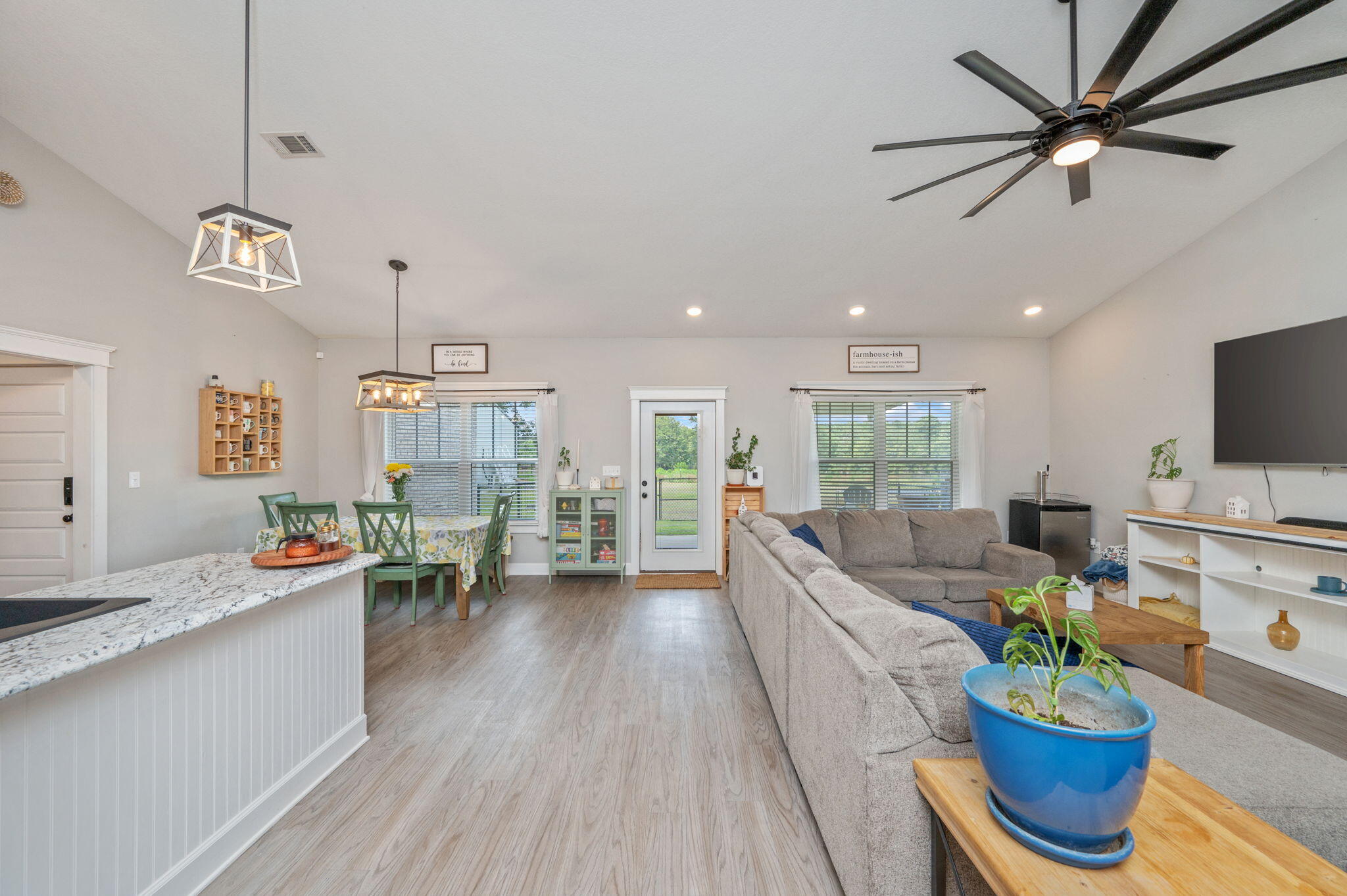7934 Steel Mill Creek Road Laurel Hill, FL 32567 - Photo 16 of 63 a living room with furniture kitchen view and a wooden floor