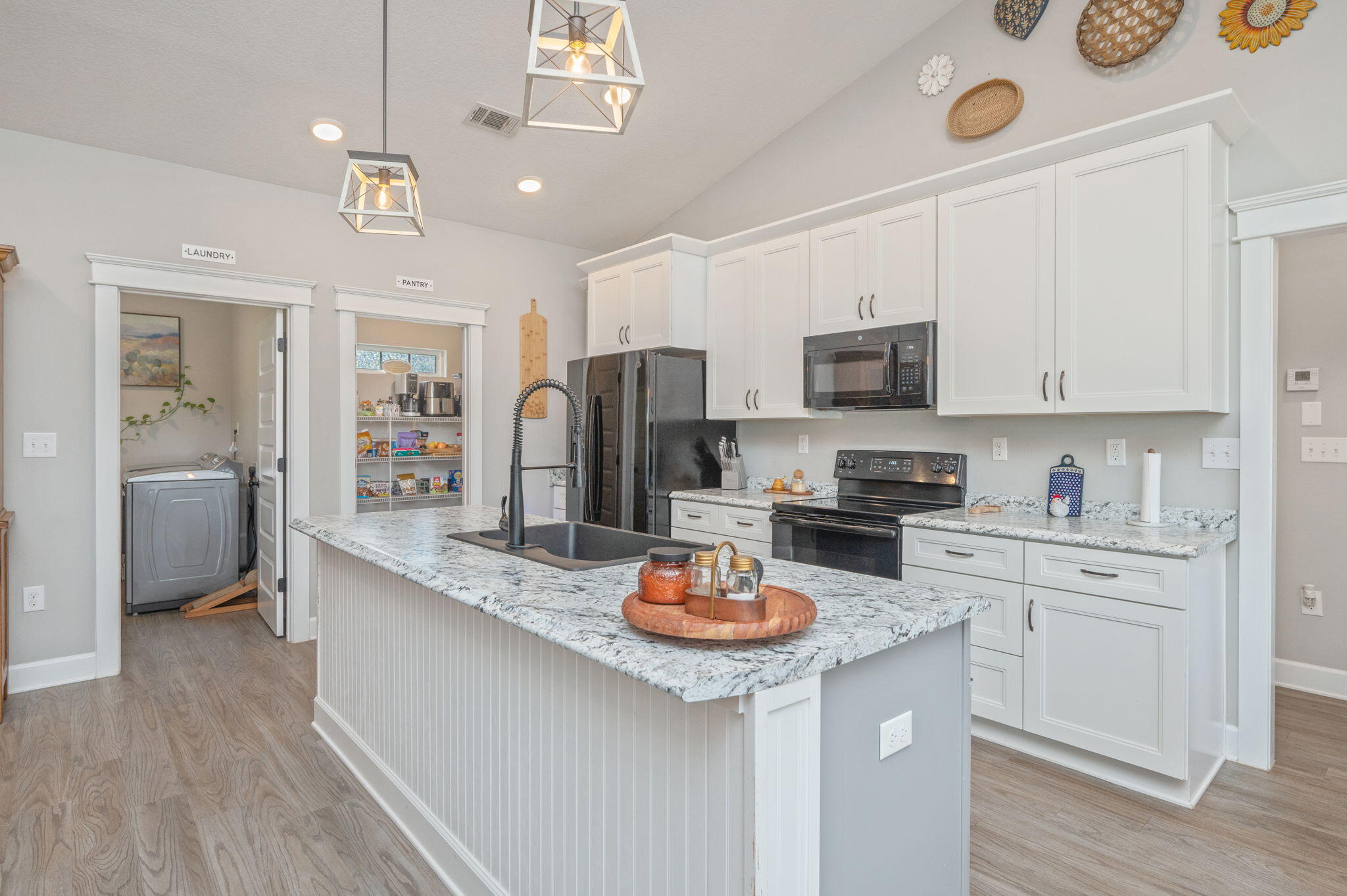 7934 Steel Mill Creek Road Laurel Hill, FL 32567 - Photo 18 of 63 a kitchen with a refrigerator a stove a sink and cabinets