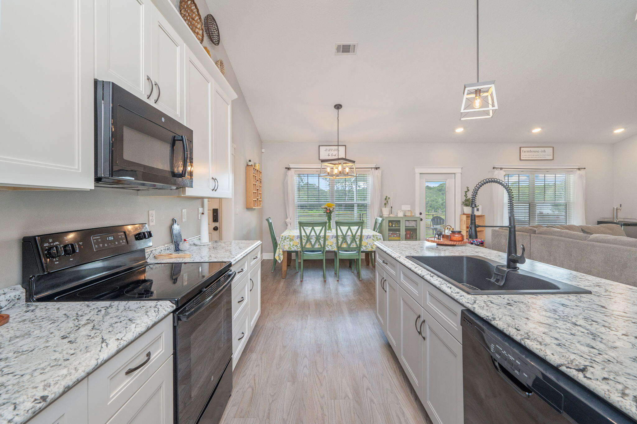 7934 Steel Mill Creek Road Laurel Hill, FL 32567 - Photo 19 of 63 a kitchen with stainless steel appliances granite countertop a sink stove and cabinets