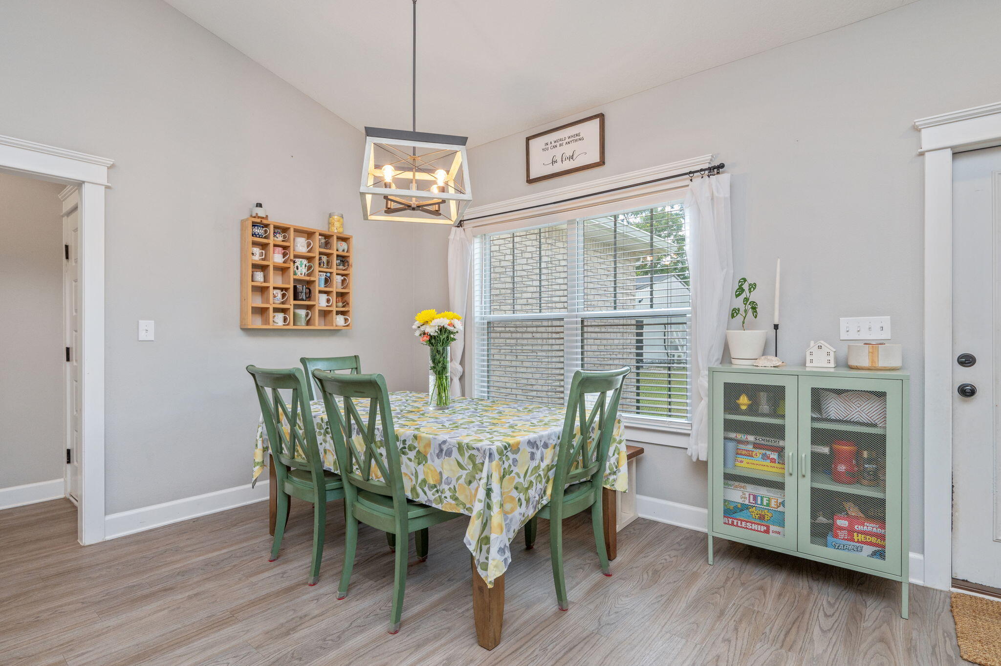 7934 Steel Mill Creek Road Laurel Hill, FL 32567 - Photo 25 of 63 a view of a dining room with furniture and wooden floor
