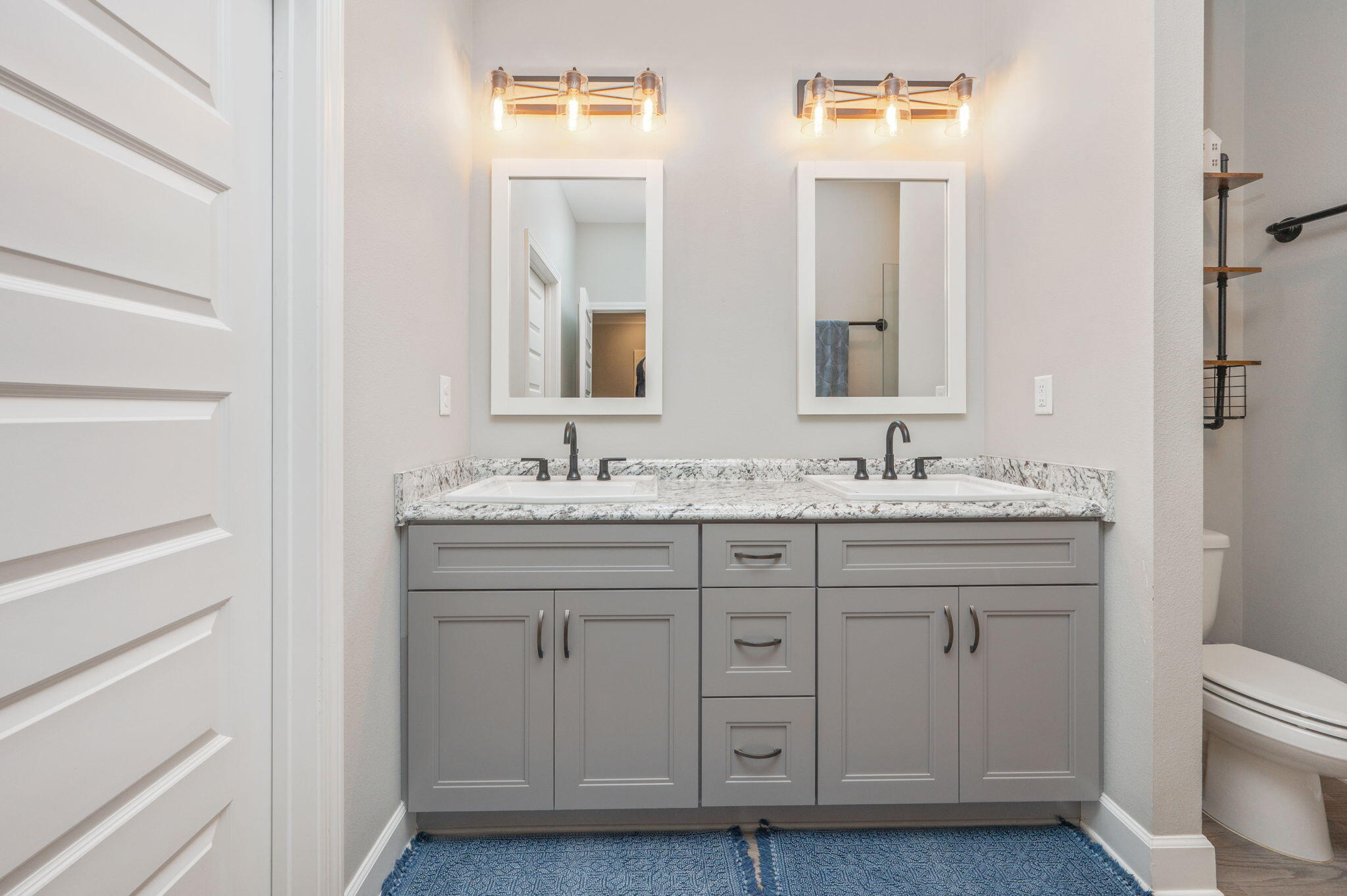 7934 Steel Mill Creek Road Laurel Hill, FL 32567 - Photo 31 of 63 a bathroom with 2 sink and a mirror