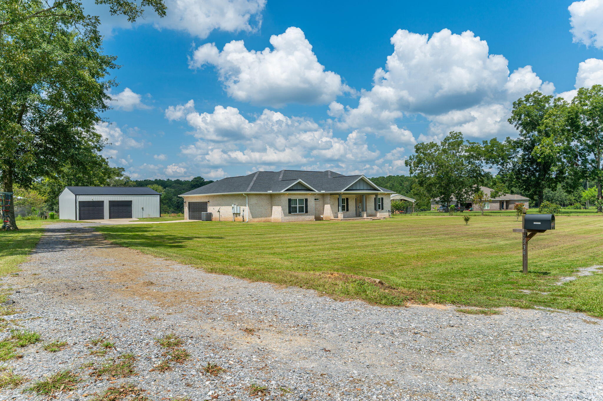 7934 Steel Mill Creek Road Laurel Hill, FL 32567 - Photo 4 of 63 a front view of a house with a yard