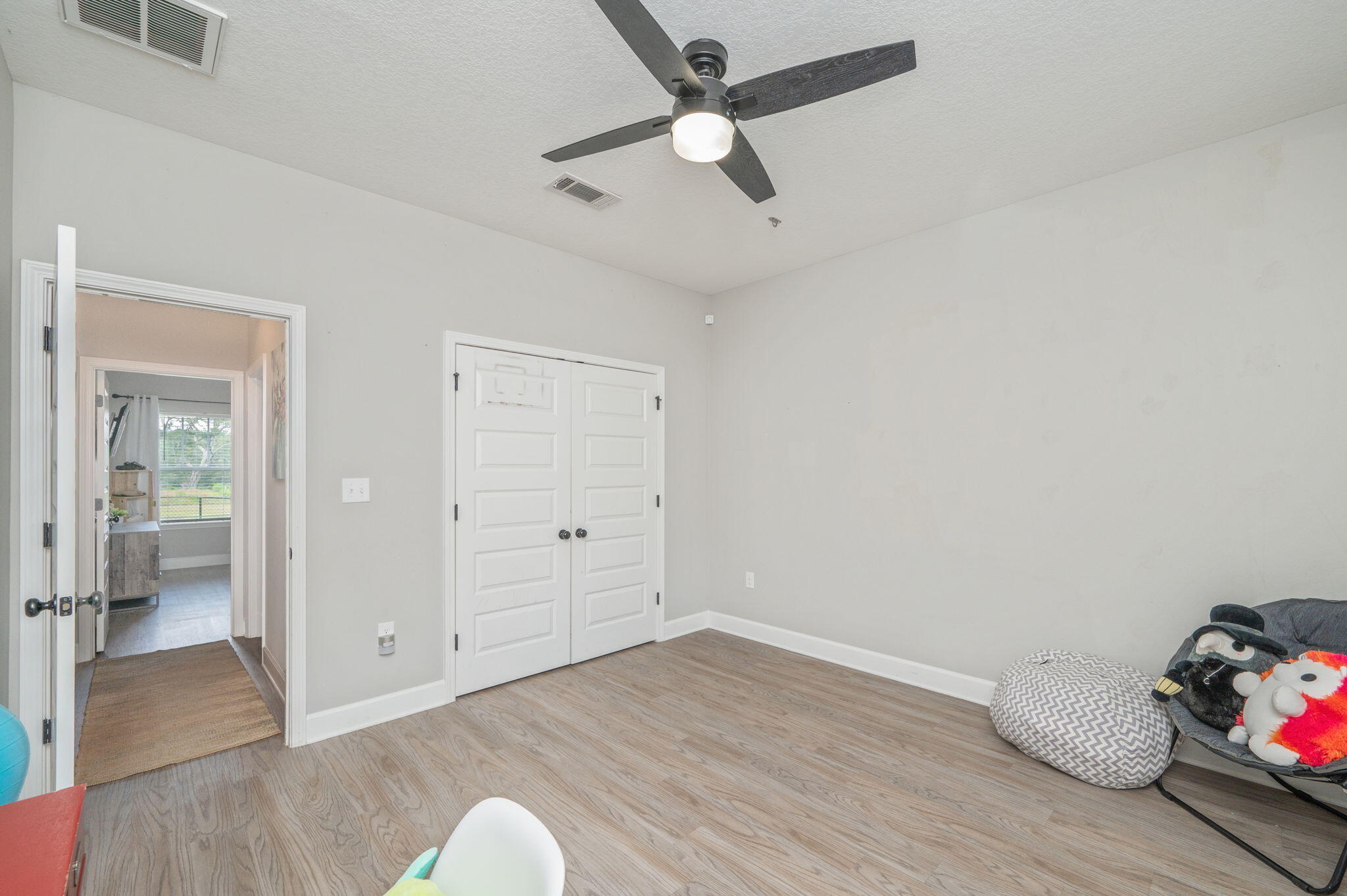 7934 Steel Mill Creek Road Laurel Hill, FL 32567 - Photo 41 of 63 wooden floor in an empty room