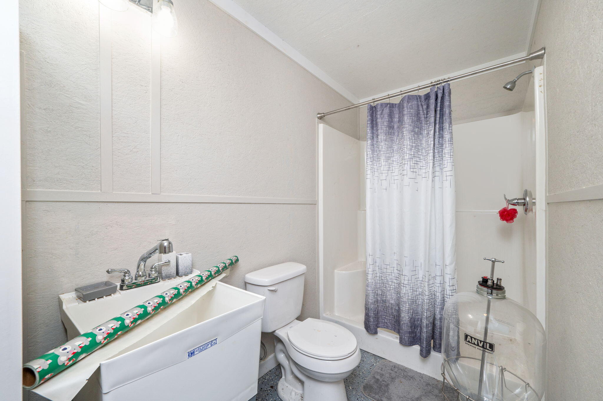 7934 Steel Mill Creek Road Laurel Hill, FL 32567 - Photo 52 of 63 a white toilet sitting next to a bathroom sink