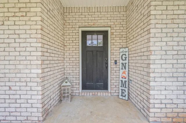 a view of hallway with stairs and wooden floor
