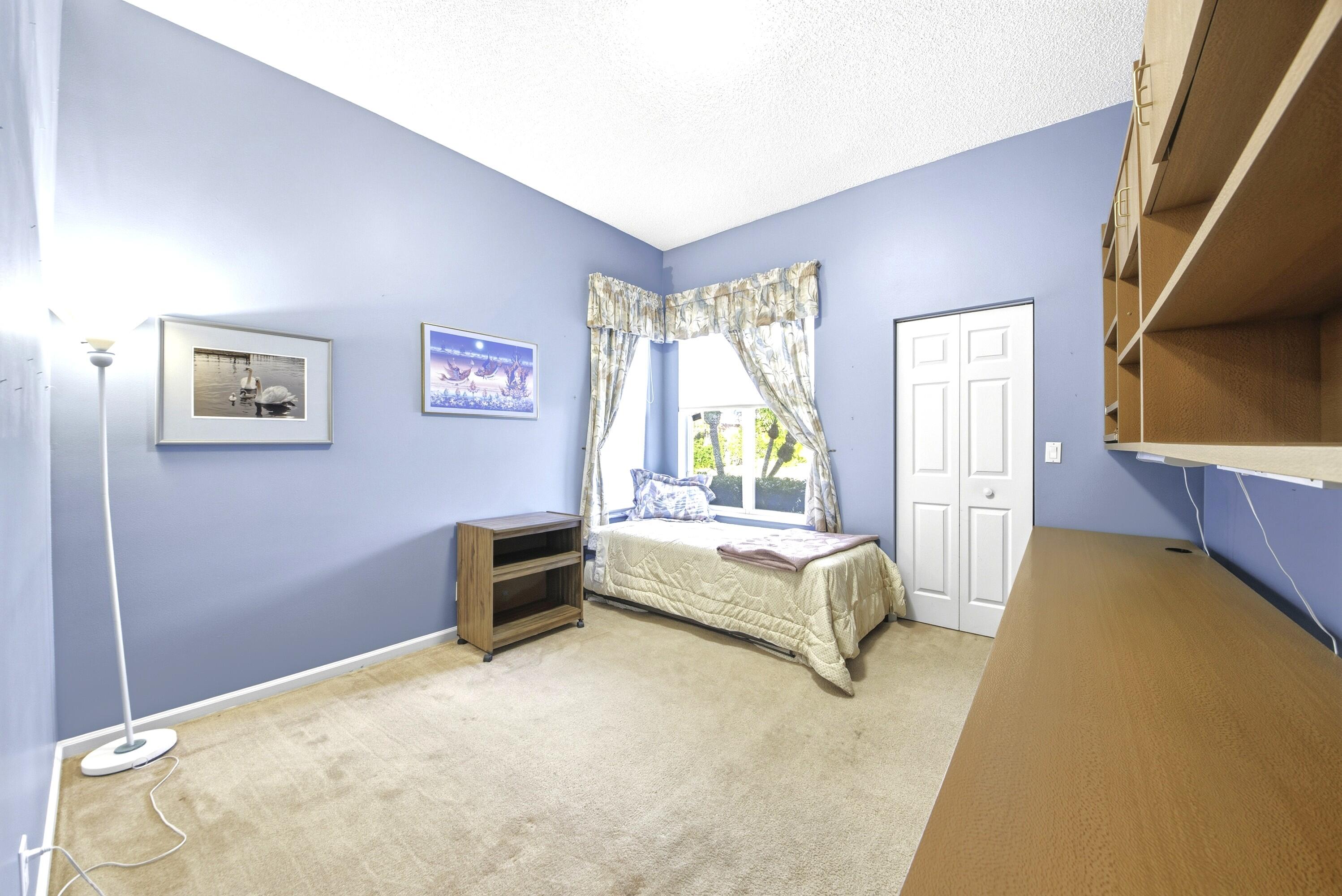 7737 Rockford Road Boynton Beach, FL 33472 - Photo 11 of 29 a bedroom with a bed and a couch