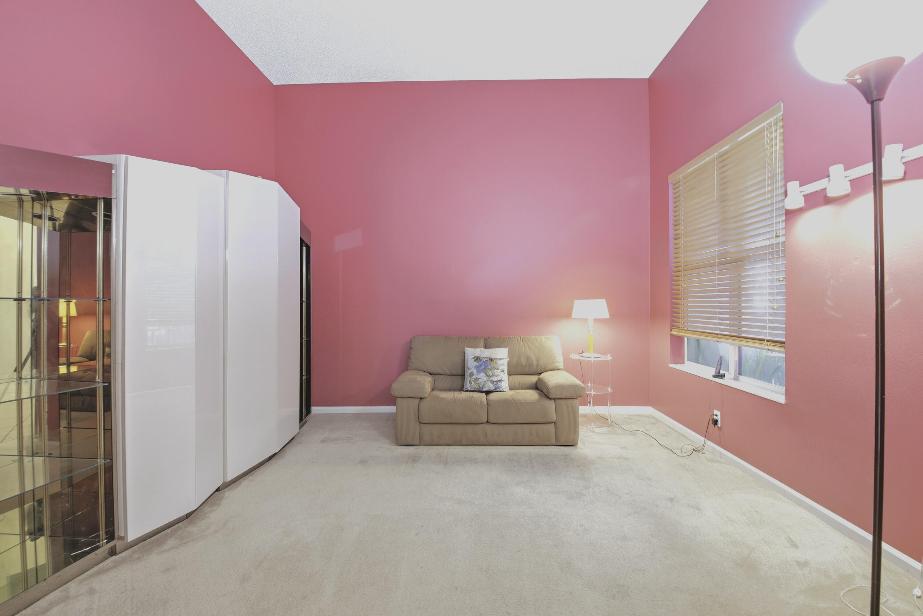 7737 Rockford Road Boynton Beach, FL 33472 - Photo 13 of 29 a bedroom with pink walls and windows