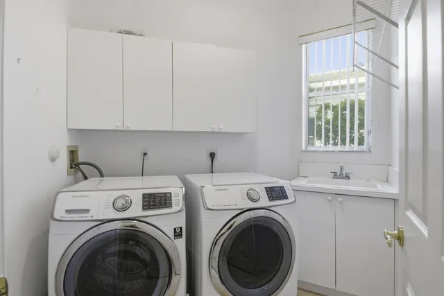 a view of a kitchen with sink washer and dryer