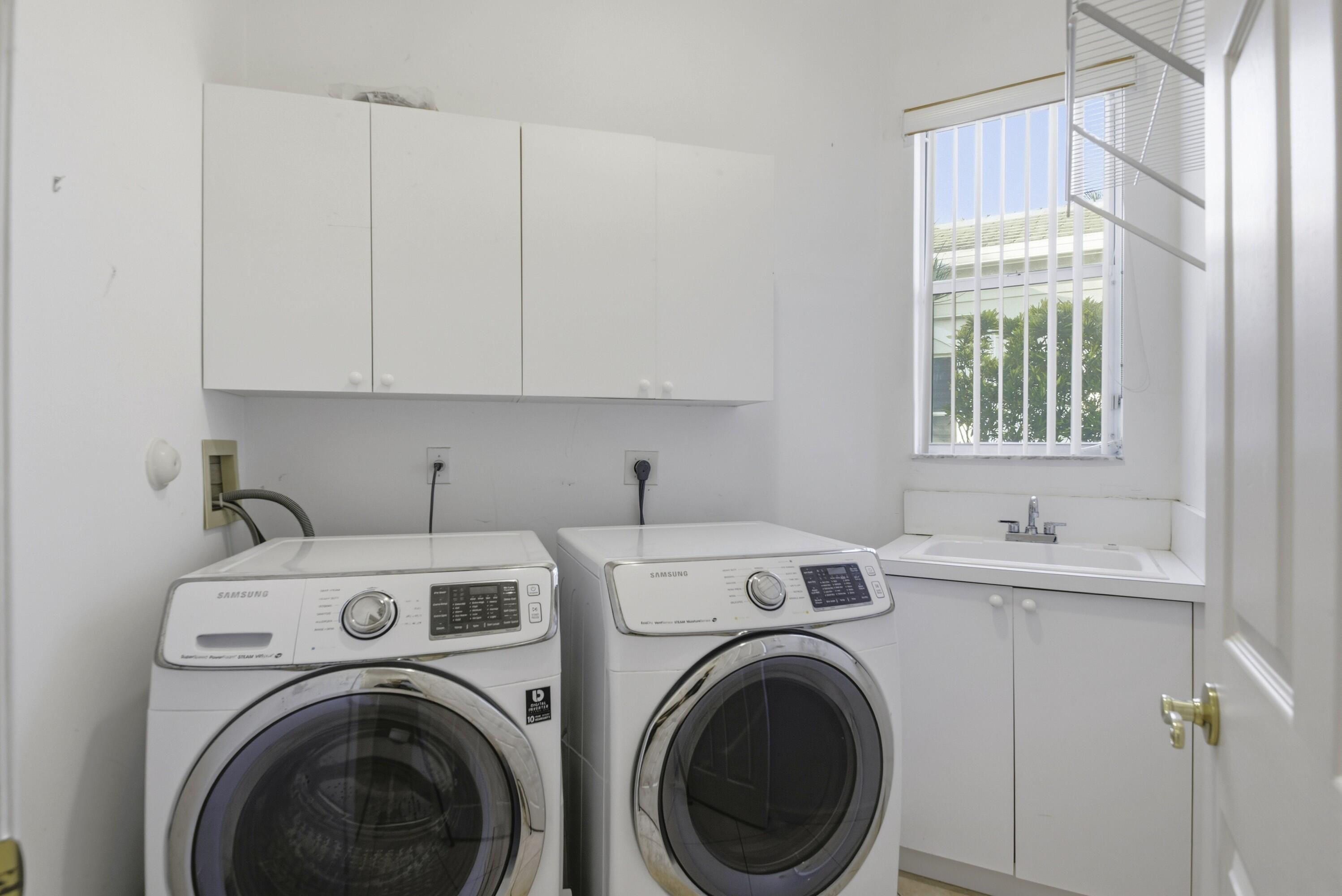 7737 Rockford Road Boynton Beach, FL 33472 - Photo 15 of 29 a view of a kitchen with sink washer and dryer