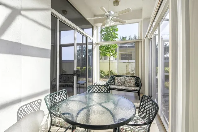 a dining room with furniture wooden floor and a chandelier