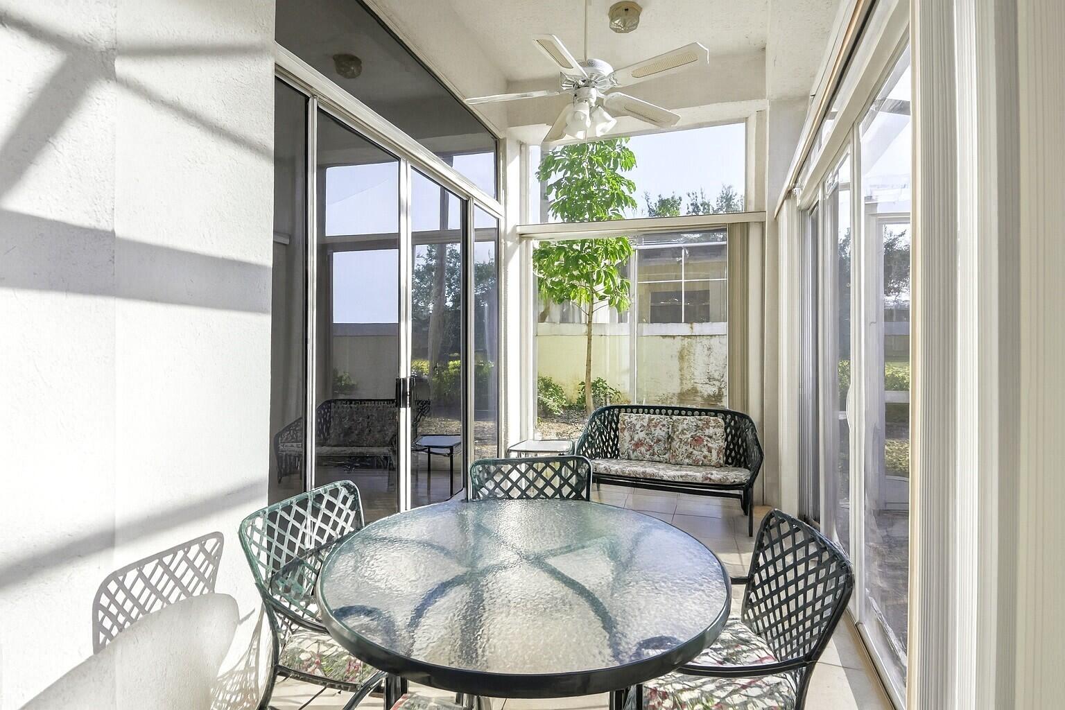 7737 Rockford Road Boynton Beach, FL 33472 - Photo 17 of 29 a dining room with furniture wooden floor and a chandelier