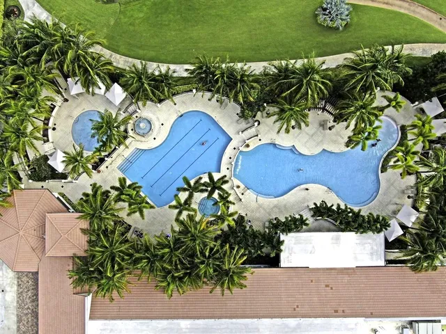 an aerial view of a house yard and swimming pool