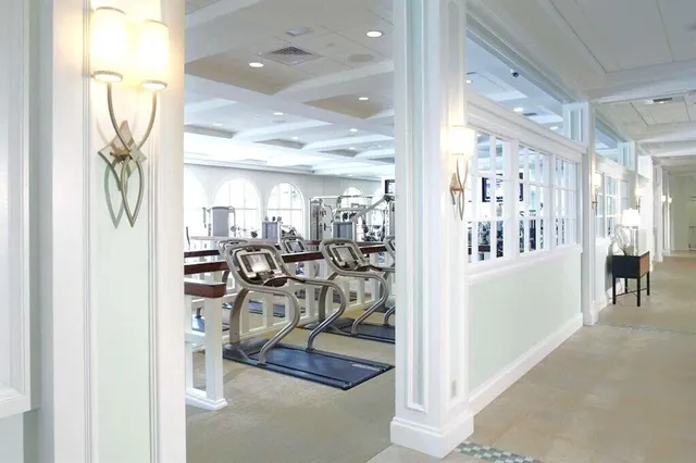 a view of a hallway with dining area and chandelier