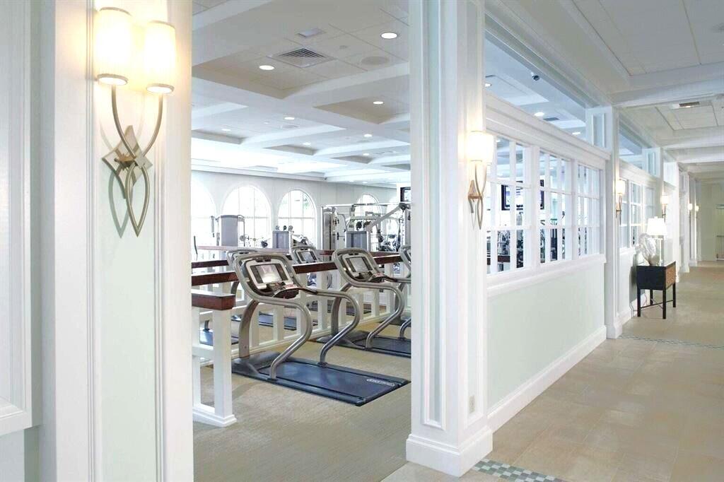 7737 Rockford Road Boynton Beach, FL 33472 - Photo 25 of 29 a view of a hallway with dining area and chandelier